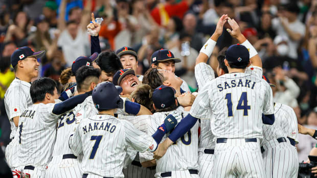 Team Japan celebrates on the field after winning the game with a walk-off double from Japan third base Munetaka Murakami (center) during the ninth inning against Mexico at LoanDepot Park.