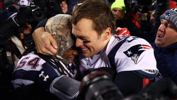 Tom Brady and Dont'a Hightower hug in celebration after beating the Chiefs in an AFC Championship game.
