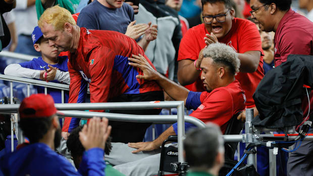 Puerto Rico pitcher Edwin Diaz (39) leaves the field on a wheelchair after an apparent leg injury during the team celebration against Dominican Republic at LoanDepot Park.