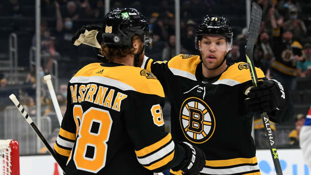 Boston Bruins right wing David Pastrnak (88) celebrates with left wing Taylor Hall (71).