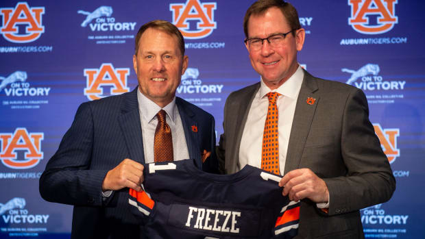 Auburn Tigers football coach Hugh Freeze and athletic director John Cohen pose for photos during Freeze’s introduction to the program.