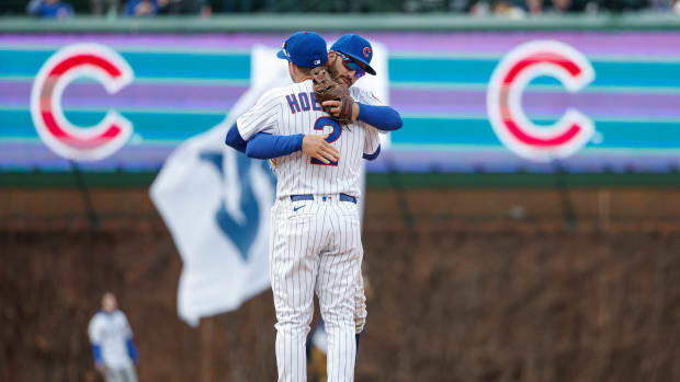 Mar 30, 2023; Chicago, Illinois, USA; Chicago Cubs second baseman Nico Hoerner (2) celebrates with shortstop Dansby Swanson (7) team's win against the Milwaukee Brewers at Wrigley Field. Mandatory Credit: Kamil Krzaczynski-USA TODAY Sports