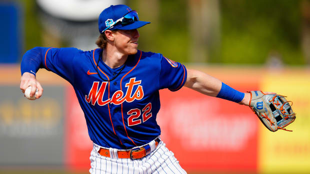 Mar 3, 2023; Port St. Lucie, Florida, USA; New York Mets third baseman Brett Baty (22) throws the ball to home against the Washington Nationals during the seventh inning at Clover Park.
