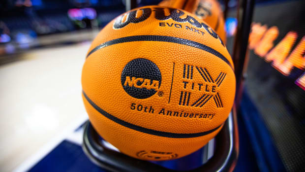 A basketball with an NCAA logo and a Title IX inscription rests on a rack before a First Four game between Illinois and Mississippi State in the NCAA women’s college basketball tournament