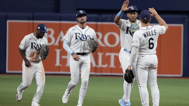 Four Rays hitters celebrate after winning a game vs. the Tigers.