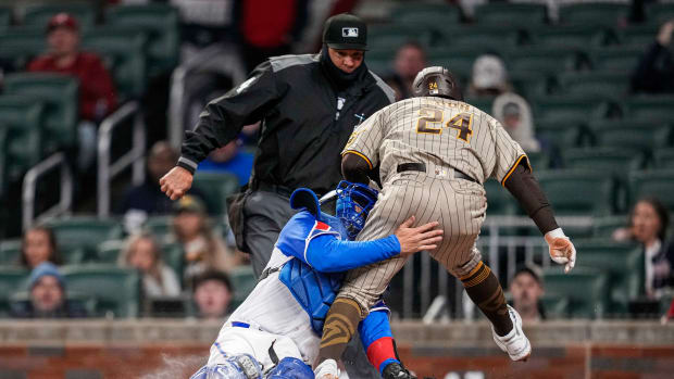 Apr 8, 2023; Cumberland, Georgia, USA; San Diego Padres right fielder Rougned Odor (24) is tagged out on a collision with Atlanta Braves catcher Travis d'Arnaud (16) during the fourth inning at Truist Park.
