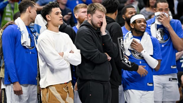 Luka Dončić and the Dallas Mavericks bench reacts to a play in a game vs. the Bulls.