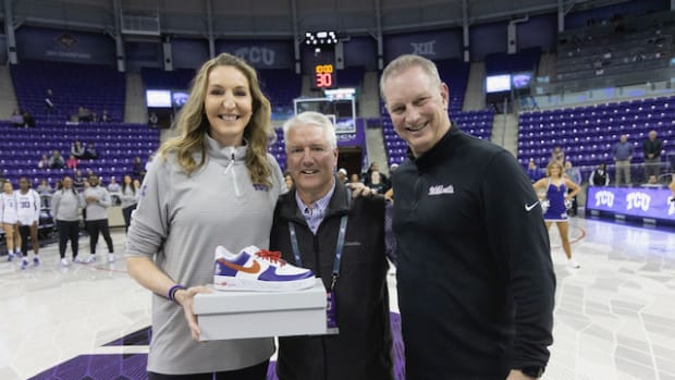 The women's basketball team honored Jeff Williams before the Kansas State game on February 18. Former TCU coaches Raegan Pebley and Jeff Mittie stand on each side of Williams.