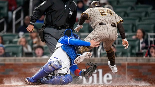 San Diego Padres right fielder Rougned Odor (24) is tagged out on a collision with Atlanta Braves catcher Travis d'Arnaud (16)