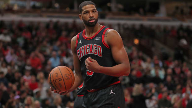 Bulls center Tristan Thompson holds a ball in a game.