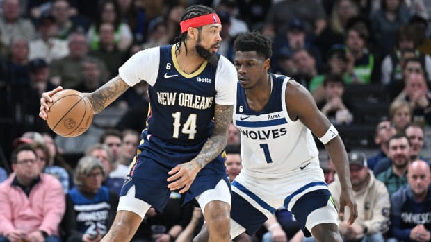 Pelicans forward Brandon Ingram (14) controls the ball as Timberwolves guard Anthony Edwards (1) defends during the last game of the 2022-23 regular season