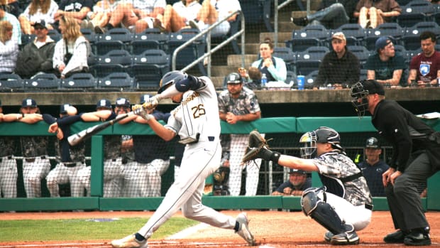 West Virginia left fielder Landon Wallace smacks an RBI single in the top of the first inning.