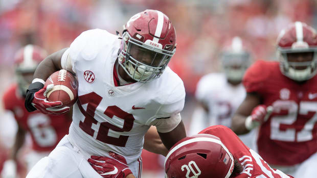 Alabama linebacker Jaylen Moody (42) shakes the tackle of wide receiver Cameron Latu (20) to score a touchdown on an interception during second half action in the 2019 Alabama A-Day spring football scrimmage game at Bryant-Denny Stadium.
