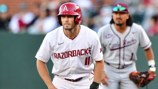 Razorbacks' Caleb Cali gets a lead off first base in a 21-5 win over Little Rock on Tuesday night.