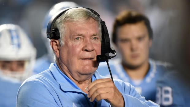 Mack Brown calls a play from the sidelines for UNC