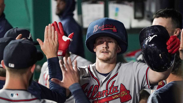 Apr 14, 2023; Kansas City, Missouri, USA; Atlanta Braves catcher Sean Murphy (12) is congratulated in the dugout after hitting a solo home run against the Kansas City Royals in the fifth inning at Kauffman Stadium.