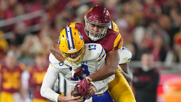 Nov 5, 2022; Los Angeles, California, USA; California Golden Bears quarterback Jack Plummer (13) is sacked by Southern California Trojans defensive lineman Tuli Tuipulotu (49) in the first half at United Airlines Field at Los Angeles Memorial Coliseum. Mandatory Credit: Kirby Lee-USA TODAY Sports