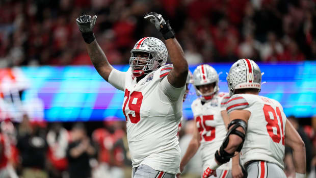 Dec 31, 2022; Atlanta, Georgia, USA; Ohio State Buckeyes offensive lineman Dawand Jones (79) celebrates a touchdown by wide receiver Marvin Harrison Jr. (18) during the first half of the Peach Bowl in the College Football Playoff semifinal at Mercedes-Benz Stadium. Mandatory Credit: Adam Cairns-The Columbus Dispatch Ncaa Football Peach Bowl Ohio State At Georgia