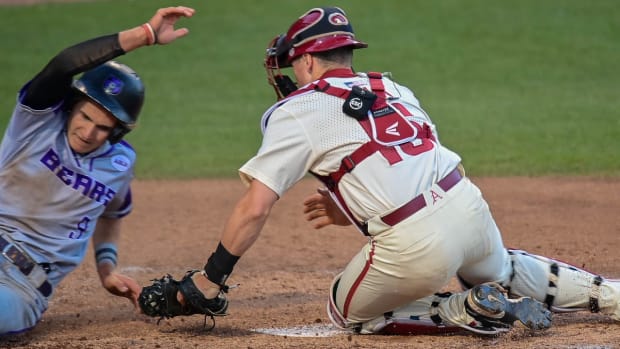 Razorbacks' Hudson Polk tags UCA's Reid Bowman on a close play at the plate that was reviewed.