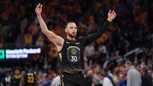 Stephen Curry hypes up the crowd during a playoff game
