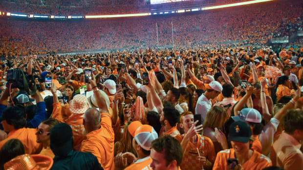 Fans storm the field after Tennessee's 52-49 win over Alabama in Neyland Stadium.