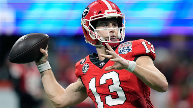 FILE - Georgia quarterback Stetson Bennett (13) warms up before the Peach Bowl NCAA college football semifinal playoff game, Saturday, Dec. 31, 2022, in Atlanta. Teams had shied away in recent years on taking a late-round flyer on quarterbacks as fewer teams kept three quarterbacks on the roster after the NFL eliminated the game-day roster exemption for an emergency third quarterback. (AP Photo/Brynn Anderson, File)