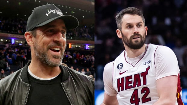Jets quarterback Aaron Rodgers attends Game 1 of the second round of the NBA playoffs between the Knicks and the Heat. Heat’s Kevin Love looks to pass the ball vs. the Pistons in 2023.