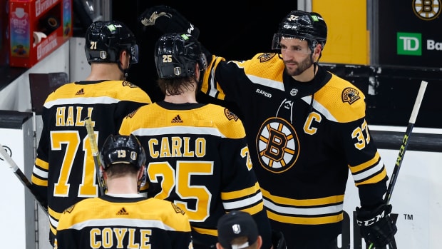 Bruins players leave the ice after losing Game 7 against the Panthers