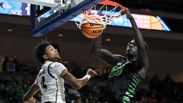 Mar 28, 2023; Las Vegas, Nevada, USA; Utah Valley Wolverines center Aziz Bandaogo (55) dunks the ball against UAB Blazers guard Eric Gaines (4) in the first half at Orleans Arena. Mandatory Credit: Candice Ward-USA TODAY Sports