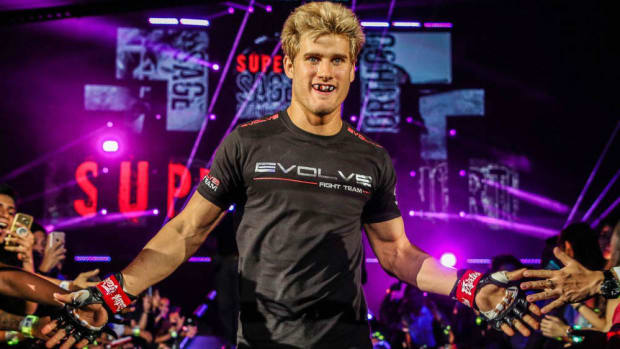 MMA fighter Sage Northcutt walks to the ring while high-fiving fans