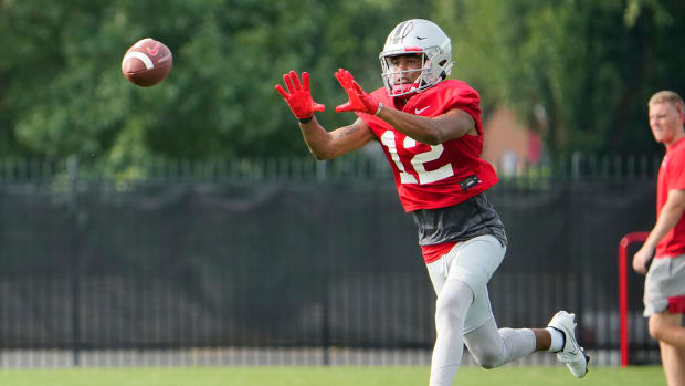 Aug 4, 2022; Columbus, OH, USA; Ohio State Buckeyes wide receiver Caleb Burton (12) catches a pass during the first fall football practice at the Woody Hayes Athletic Center. Mandatory Credit: Adam Cairns-The Columbus Dispatch Ohio State Football First Practice