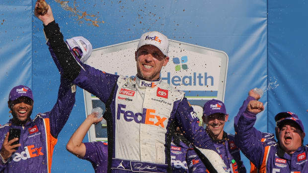 Denny Hamlin celebrates in victory lane after winning Sunday's NASCAR Cup Series Advent Health 400 at Kansas Speedway. (Photo by Jonathan Bachman/Getty Images)