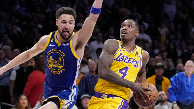 Lakers guard Lonnie Walker IV, right, drives the ball as Warriors guard Klay Thompson defends during Game 4