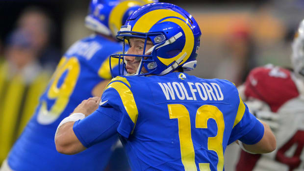 Los Angeles Rams quarterback John Wolford (13) throws a pass in the second half against the Arizona Cardinals at SoFi Stadium.