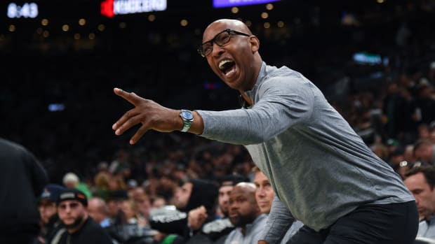 Philadelphia 76ers assistant coach Sam Cassell reacts to a play