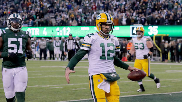 QB Aaron Rodgers celebrates a TD by pantomiming a championship belt