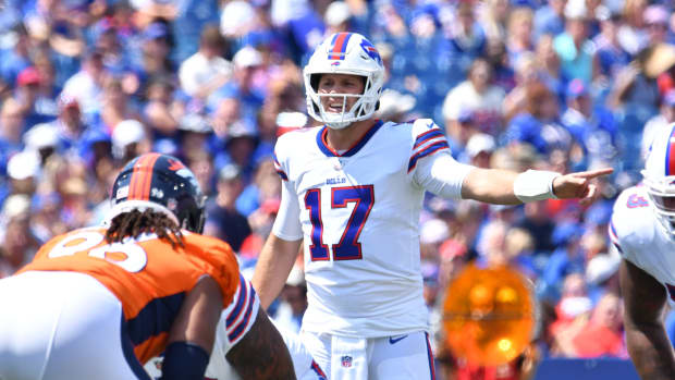 Buffalo Bills quarterback Josh Allen (17) at the line of scrimmage in the first quarter of a pre-season game against the Denver Broncos at Highmark Stadium.