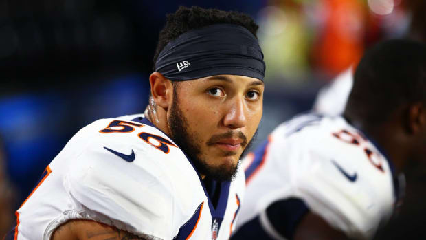Broncos linebacker Shane Ray looks on from the sidelines without a helmet.