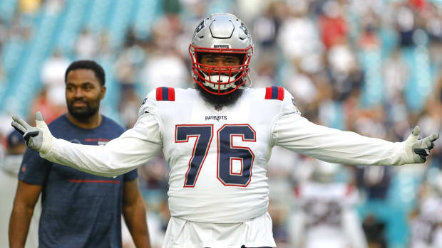 Patriots offensive tackle Isaiah Wynn reacts while warming up before a game.