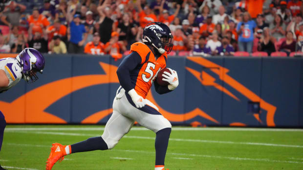 Aug 27, 2022; Denver, Colorado, USA; Denver Broncos linebacker Baron Browning (56) runs for a touchdown after picking up a fumble in the second quarter against the Minnesota Vikings at Empower Field at Mile High.