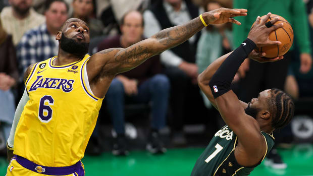Lakers’ LeBron James tries to block Celtics’ Jaylen Brown’s shot.