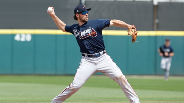 Mar 12, 2020; Lakeland, Florida, USA; Atlanta Braves infielder Charlie Culberson (8) thyrows to firsat for the inning ending out during the fourth inning against the Detroit Tigers at Publix Field at Joker Marchant Stadium.