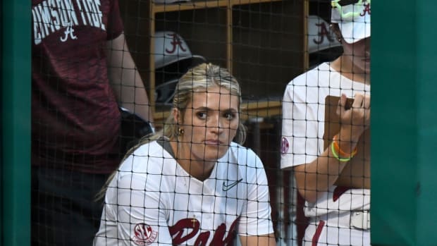 Alabama pitcher Montana Fouts (14) wears a brace on her left knee as she watches from the dugout as the Crimson Tide played Long Island University Friday, May 19, 2023, at Rhoads Stadium in the Tuscaloosa Regional of the NCAA Tournament.