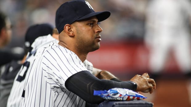 Yankees outfielder Aaron Hicks looks on from the dugout during a game.