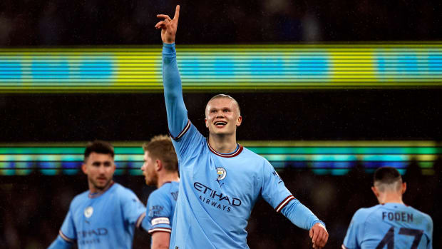 Erling Haaland celebrates a goal with Man City teammates.