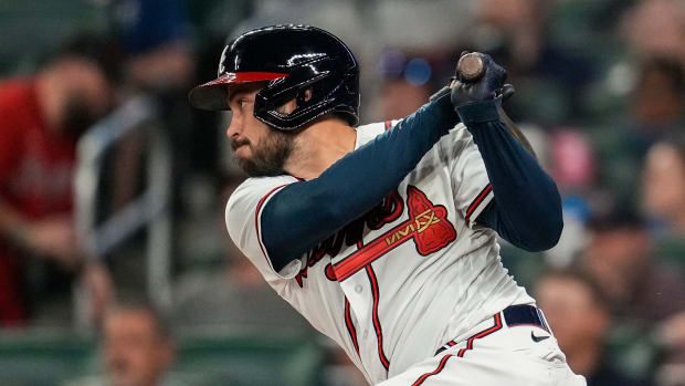 Apr 6, 2023; Cumberland, Georgia, USA; Atlanta Braves designated hitter Travis d'Arnaud (16) drives in the game tying run with a single against the San Diego Padres during the eighth inning at Truist Park.