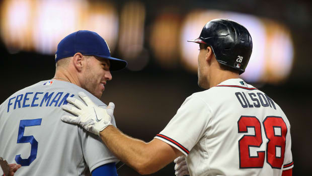 Jun 26, 2022; Atlanta, Georgia, USA; Los Angeles Dodgers first baseman Freddie Freeman (5) talks to Atlanta Braves first baseman Matt Olson (28) in the tenth inning at Truist Park.