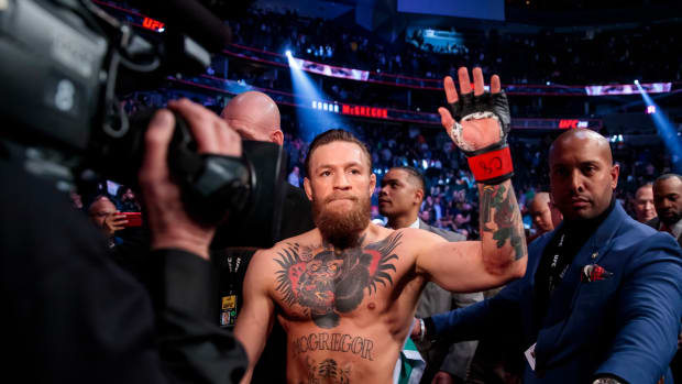 Conor McGregor, shirtless, waves to crowd