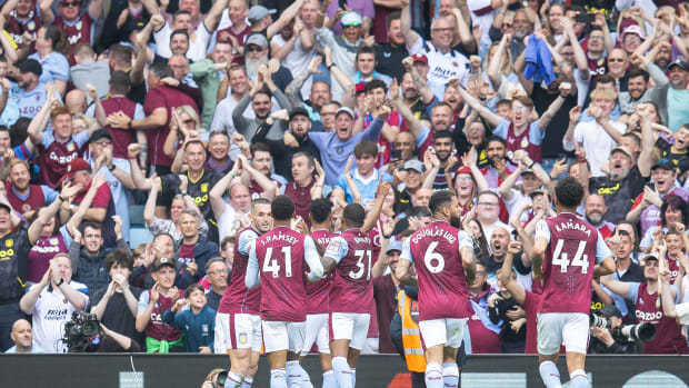 Aston Villa players pictured celebrating after scoring a goal against Brighton in May 2023