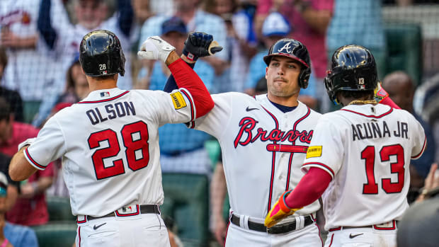 May 28, 2023; Cumberland, Georgia, USA; Atlanta Braves first baseman Matt Olson (28) reacts with third baseman Austin Riley (27) and right fielder Ronald Acuna Jr. (13) after hitting a home run against the Philadelphia Phillies during the first inning at Truist Park.